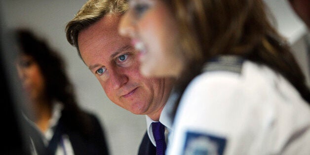 LONDION - OCTOBER 10: Prime Minister David Cameron watches security monitors as he talks to UK border agency officials in their control room during a visit to Heathrow terminal 5, on October 10, 2011 in London, England. Cameron's visit to the airport comes ahead of his talk on immigration controls. (Photo by Richard Pohle - WPA Pool/Getty Images)