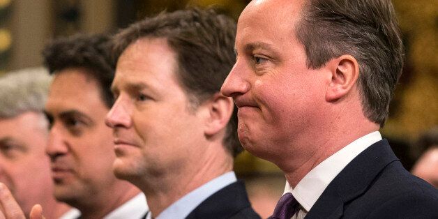 British Prime Minister, David Cameron (R), Britain's Deputy Prime Minister, Nick Clegg (2nd R) and British opposition Labour Party leader, Ed Miliband (L), react while listening to German Chancellor Angela Merkel's address to both Houses of Parliament in the Royal Gallery of the Palace of Westminster on February 27, 2014 in London. German Chancellor Angela Merkel urged Britain Thursday to stay in the EU but played down David Cameron's hopes that her visit to London would bring major reforms. The British premier rolled out the red carpet in his bid to woo fellow conservative Merkel, who gave a speech to both houses of parliament and was due to have tea with the queen. AFP PHOTO/POOL/OLI SCARFF (Photo credit should read OLI SCARFF/AFP/Getty Images)