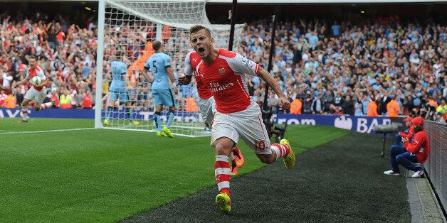 LONDON, ENGLAND - SEPTEMBER 13: Jack Wilshere celebrates scoring for Arsenal during the Barclays Premier League match between Arsenal and Manchester City at Emirates Stadium on September 13, 2014 in London, England. (Photo by Stuart MacFarlane/Arsenal FC via Getty Images)