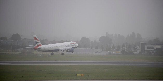 A plane lands at Heathrow Airport, west London as much of southern England has been blanketed in thick fog with flights delayed as visibility dips to less than 100 metres in places