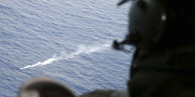 An observer watch a smoke fare after it was deployed to mark an unidentified object spotted from a RNZAF P3 Orion during search operations for wreckage and debris of missing Malaysia Airlines Flight MH370 in the Southern Indian Ocean, near the coast of Western Australia on April 4, 2014. A US Navy 'black box' detector made its much-anticipated debut in the oceanic hunt for flight MH370 on April 4 but Australia's search chief warned it was crunch time with the box's signal set to expire soon. AF