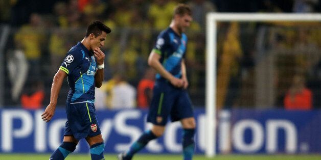 DORTMUND, GERMANY - SEPTEMBER 16: Alexis Sanchez and Per Mertesacker of Arsenal looks dejected during the UEFA Champions League Group D match between Borussia Dortmund and Arsenal at Signal Iduna Park on September 16, 2014 in Dortmund, Germany. (Photo by Friedemann Vogel/Bongarts/Getty Images)