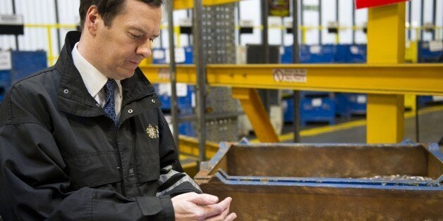 Britain's Chancellor of the Exchequer George Osborne holds freshly minted coins during a visit to the Royal Mint in Llantrisant, Wales on March 25, 2014. In events surrounding the Chancellor's recent budget, a new design was revealed for a 12-sided one pound coin, designed to be much harder to fake and based on the pre-decimal 'threepenny bit' three pence piece. AFP PHOTO/POOL/Matthew Horwood (Photo credit should read MATTHEW HORWOOD/AFP/Getty Images)