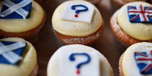 'Referendum cupcakes' featuring a Scottish Saltire, (L) a Union flag (R) and a question mark (C) symbolising the 'undecided voter' are pictured in a bakery in Edinburgh, Scotland, on September 16, 2014, ahead of the referendum on Scotland's independence. The leaders of the three main British parties on Tuesday issued a joint pledge to give the Scottish parliament more powers if voters reject independence, in a final drive to stop the United Kingdom splitting. AFP PHOTO / BEN STANSALL (Ph