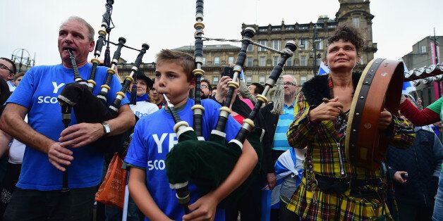 GLASGOW, SCOTLAND - SEPTEMBER 18: Pipers play in George Square, just a few hours before polling stations will close in the Scottish independence referendum on September 18, 2014 in Glasgow, Scotland. After many months of campaigning the people of Scotland today head to the polls to decide the fate of their country. The referendum is too close to call but a Yes vote would see the break-up of the United Kingdom and Scotland would stand as an independent country for the first time since the format