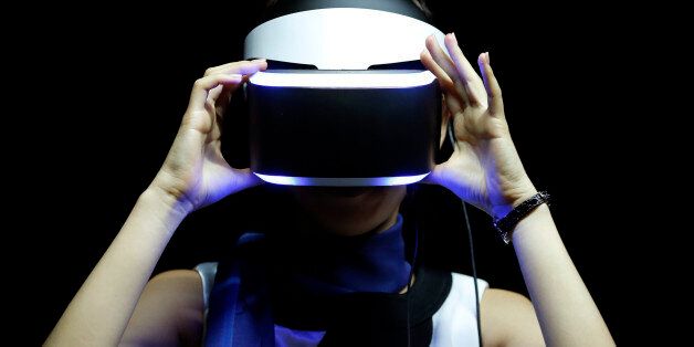 A booth attendant wears the Sony Corp. Project Morpheus virtual reality headset during a demonstration for a photograph at the Tokyo Game Show 2014 in Chiba, Japan, on Thursday, Sept. 18, 2014. Sony plans to boost cloud-based gaming by creating a mass-market streaming service similar to Netflix Inc.'s as the PlayStation maker tries to rebound from a projected $2.1 billion annual loss. Photographer: Kiyoshi Ota/Bloomberg via Getty Images