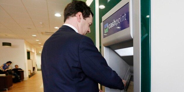 LONDON, ENGLAND - JUNE 19: Britain's Chancellor of the Exchequer George Osborne withdraws money from a cash machine during a visit to a branch of LloydsTSB bank on June 19, 2013 in London, England. The Chancellor, is expected to outline the government's plans for the future of banks Lloyds and Royal Bank of Scotland during a speech at the Lord Mayor's Bankers and Merchants Dinner at Mansion House later. (Luke MacGregor - WPA Pool/Getty Images)