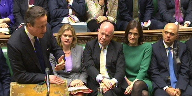 Prime Minister David Cameron speaks and new Culture Secretary Sajid Javid MP (right) listens during Prime Minister's Questions in the House of Commons, London.