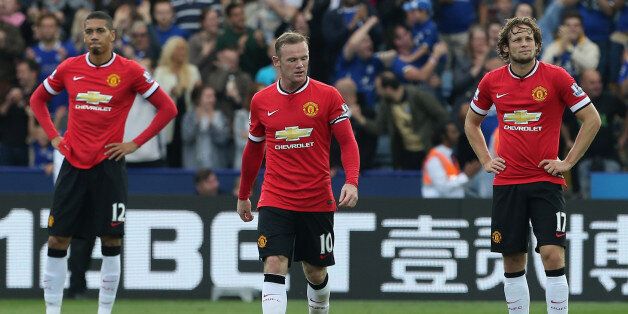 LEICESTER, ENGLAND - SEPTEMBER 21: Chris Smalling, Adnan Januzaj and Wayne Rooney of Manchester United show their disappointment during the Barclays Premier League match between Leicester City and Manchester United at The King Power Stadium on September 21, 2014 in Leicester, England. (Photo by John Peters/Man Utd via Getty Images)