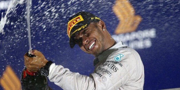 SINGAPORE - SEPTEMBER 21: Lewis Hamilton of Great Britain and Mercedes GP celebrates on the podium after winning the Singapore Formula One Grand Prix at Marina Bay Street Circuit on September 21, 2014 in Singapore, Singapore. (Photo by isifa/Jiri Krenek)