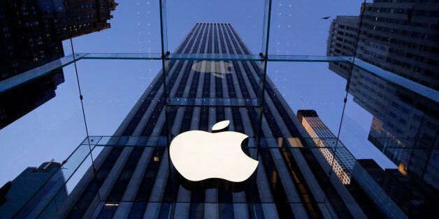The Apple logo hangs in the glass box entrance to the company's Fifth Avenue store, Thursday, Sept. 5, 2014 in New York. (AP Photo/Mark Lennihan)