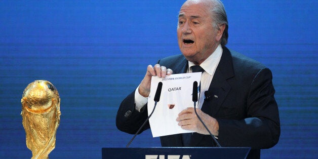 FIFA president Joseph Blatter opens the envelope to reveal that Qatar will host the 2022 World Cup at the FIFA headquarters in Zurich on December 2, 2010. Qatar became the first Arab, Middle Eastern or Muslim country to be awarded the right to stage football's World Cup. AFP PHOTO/KARIM JAAFAR (Photo credit should read KARIM JAAFAR/AFP/Getty Images)