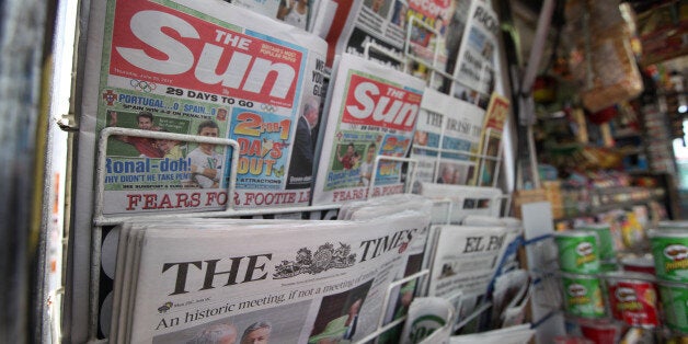 Copies of News Corp.'s newspaper titles, The Sun and The Times, are seen for sale on a newsagent's stand in London, U.K., on Thursday, June 28, 2012. News Corp.'s board approved in principle a plan to split the company's publishing unit from entertainment, a person with knowledge of the situation said. Photographer: Chris Ratcliffe/Bloomberg via Getty Images