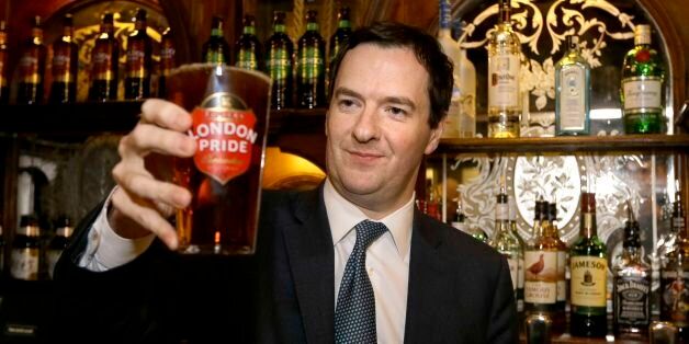 Chancellor of the Exchequer George Osborne holds a pint of beer during a visit to officially re-open The Red Lion pub, following a major refurbishment in Whitehall, central London.