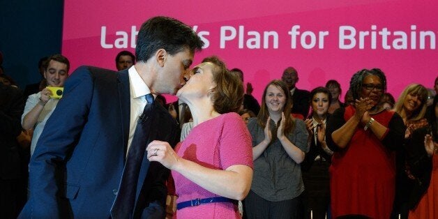 Justine Thornton (R) wife of the leader of Britain's opposition Labour Party Ed Miliband kisses her husband following his speech at Manchester Central, in Manchester on September 23, 2014 on the third day of the Labour Party conference. Conservative bashing, stirring words about social equality and warnings over populism: Britain's main opposition party this week prepped its ranks for next year's general election. 'Win 2015' flags were on display all around at the party conference in Manchester,