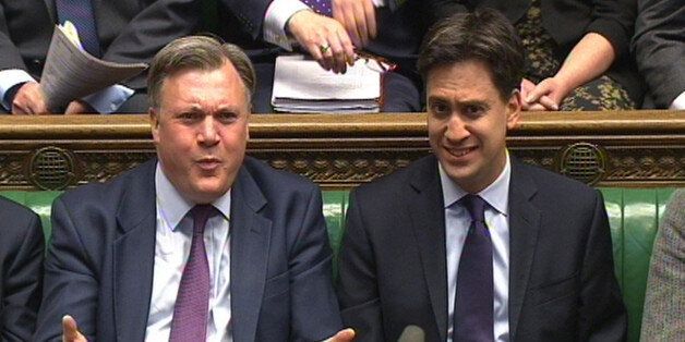 Shadow Chancellor Ed Balls (left) and Labour party leader Ed Miliband (right) listen during Prime Minister's Questions in the House of Commons, London.