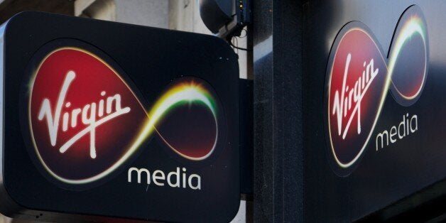 A Virgin Media sign is displayed above the company's shop on Oxford Street in central London on February 6, 2013. US-based cable operator Liberty Global said late on February 5, 2013 that it will acquire Virgin Media in a stock and cash merger valued at USD $23.3 billion, eyeing key strategic markets in Europe. AFP PHOTO/ANDREW COWIE (Photo credit should read ANDREW COWIE/AFP/Getty Images)