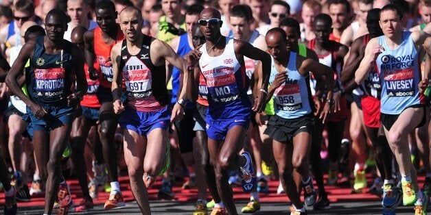 British Olympic double gold medallist Mo Farah (C) competes in the 2014 London Marathon as it passes through Blackheath in southeast London on April 13, 2014. Near-ideal sunny and clear conditions greeted the first runners to start the London Marathon with fans hoping for a fast pace by British favourite Mo Farah in his debut over the distance. AFP PHOTO / CARL COURT (Photo credit should read CARL COURT/AFP/Getty Images)