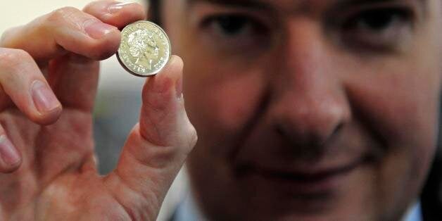 CARDIFF, WALES - MARCH 5: Chancellor of the Exchequer George Osborne, poses with a newly minted one pound coin during a visit to the Royal Mint on March 5, 2011 in Cardiff, United Kingdom. The Conservative Party is in Wales for it's annual spring forum. (Photo by Toby Melville - WPA Pool/GEtty Images)