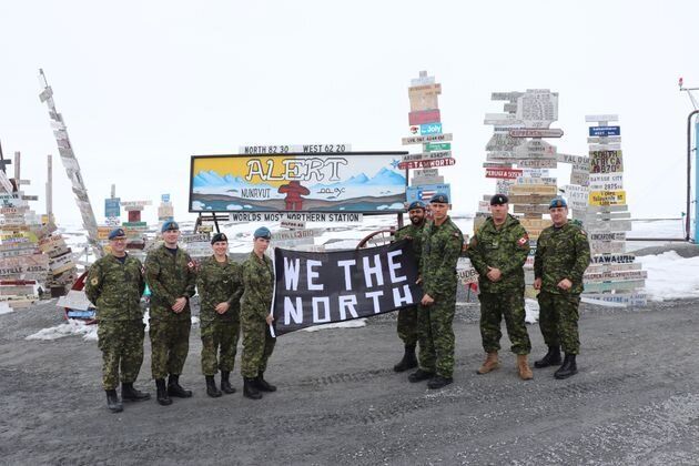 Canadian Armed Forces members hold up a banner in support of the Toronto Raptors in Alert, Nunavut.