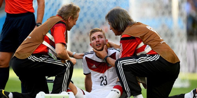 RIO DE JANEIRO, BRAZIL - JULY 13: Christoph Kramer of Germany receives a medical treatment during the 2014 FIFA World Cup Brazil Final match between Germany and Argentina at Maracana on July 13, 2014 in Rio de Janeiro, Brazil. (Photo by Shaun Botterill - FIFA/FIFA via Getty Images)