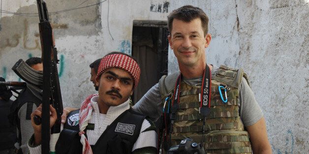 In this Nov. 11, 2012 photo, freelance British photojournalist John Cantlie poses with a Free Syrian Army rebel in Aleppo, Syria
