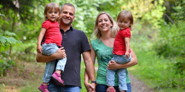 Identical twins with their parents (file)