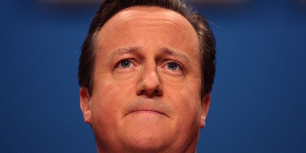 David Cameron, U.K. prime minister, pauses as he addresses delegates at the Conservative party's annual conference in Birmingham, U.K., on Wednesday, Oct. 1, 2014. Cameron pledged to cut taxes for people on middle incomes as well as the lowest paid if he wins next year's general election, taking the fight to the Labour opposition that's leading in the polls. Photographer: Chris Ratcliffe/Bloomberg via Getty Images
