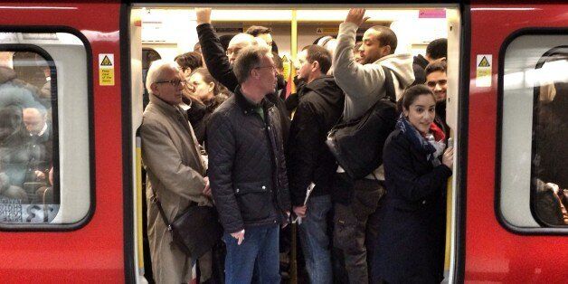 Passengers squeeze on to a busy tube train during strike, at kings cross station.