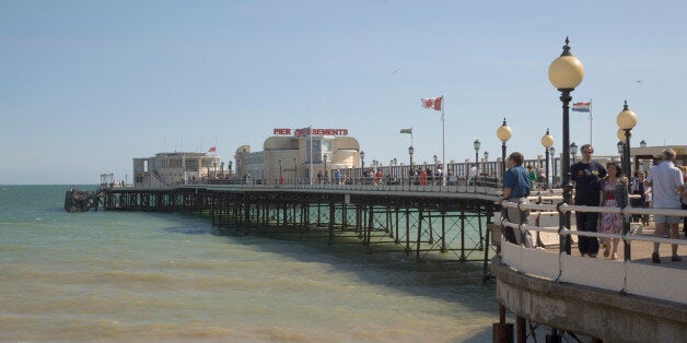 ENGLAND West Sussex Worthing People walking along the promenade deck on Worthing Pier