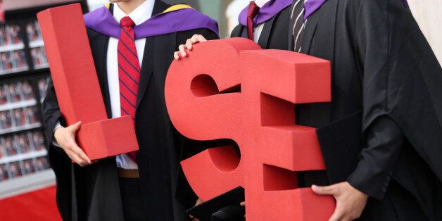 Students from the London School of Economics & Political Science (LSE) pose for a photograph with the letters reading 'LSE' during a ceremony for university graduates in London, U.K., on July 18, 2013. U.K. unemployment claims fell at their fastest pace in three years in June, adding to evidence the economic recovery is gaining momentum. Photographer: Chris Ratcliffe/Bloomberg via Getty Images
