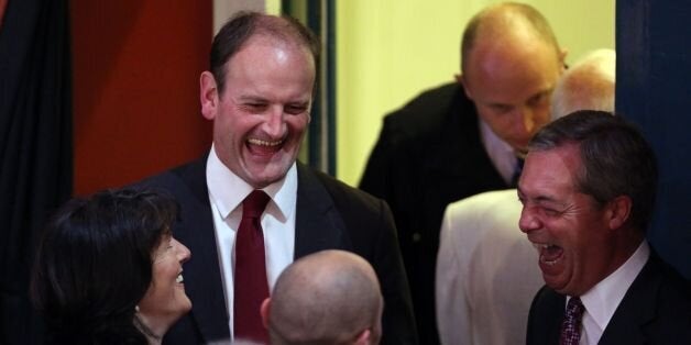 Douglas Carswell, with his wife Clementine share a joke with UKIP party leader Nigel Farage as they wait for the results of the Clacton constituency parliamentary by-election