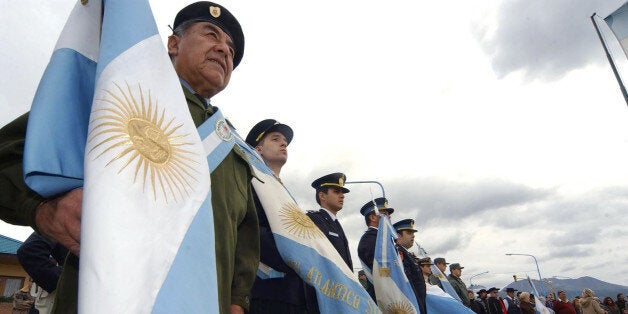 British Royal Navy handout image of Argentine veterans of the Falklands Campaign bearing standards in memory of those who lost their lives attend a memorial ceremony in Ushuaia, 2,150 miles south of the capital, Buenos Aires Tuesday Jan. 24, 2006. A British warship anchored in Argentina for the first time since the two countries went to war over the Falkland Islands 23 years ago, meeting a chilly reception in its homage to those who died in the conflict. The captain of the icebreaker HMS Endurance, Nick Lambert, and interim Tierra del Fuego Governor Carlos Saladino presided over Tuesday's memorial ceremony. (AP Photo/Matt Ellison/British Royal Navy) ** UNITED KINGDOM OUT NO SALES **