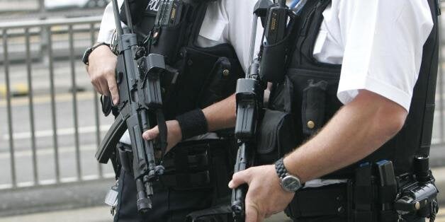 Armed police outside Heathrow Airport's Terminal 4, as airport security was being increased at British airports after the United States called for heightened precautions amid reports two terror networks are working together on a bomb that could evade existing measures.