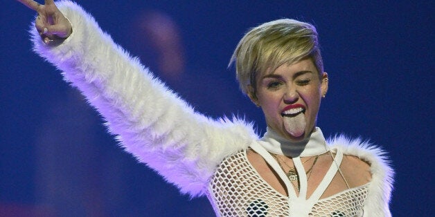 LAS VEGAS, NV - SEPTEMBER 21: Entertainer Miley Cyrus winks and sticks out her tongue as she performs during the iHeartRadio Music Festival at the MGM Grand Garden Arena on September 21, 2013 in Las Vegas, Nevada. (Photo by Ethan Miller/Getty Images for Clear Channel)