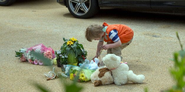 Members of the public lay flowers at a house in New Malden, south London