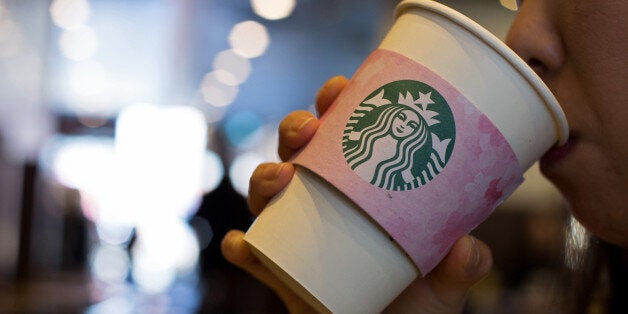 A customer drinks a coffee at a Starbucks Coffee Korea Co. store in Gimpo, South Korea, on Friday, March 7, 2014. Starbucks Korea's 'returning-mom' program is part of a drive to raise female participation in Asia's fourth-largest economy as the nation's first female leader, President Park Geun Hye, tries to counter the effects of an aging population. Photographer: SeongJoon Cho/Bloomberg via Getty Images