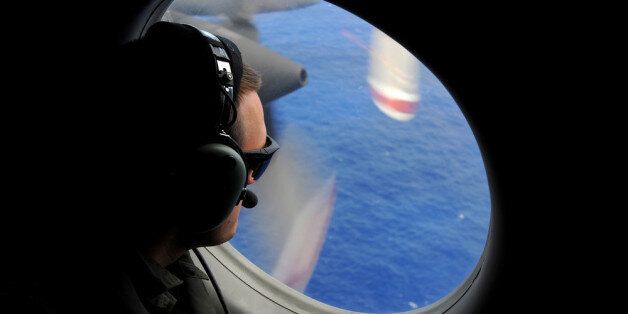 IN FLIGHT - APRIL 11: A crew member of a Royal New Zealand Airforce (RNZAF) P-3K2-Orion aircraft helps to look for objects during the search for missing Malaysia Airlines flight MH370 in flight over the Indian Ocean on April 13, 2014 off the coast of Perth, Australia. Search and rescue officials in Australia are confident they know the approximate position of the black box recorders from missing Malaysia Airlines Flight MH370, Australian Prime Minister Tony Abbott said on Friday. At the same tim