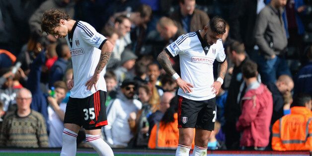 LONDON, ENGLAND - APRIL 26: Goalscorers Fernando Amorebieta and Ashkan Dejagah of Fulham look dejected at the final whistle during the Barclays Premier League match bewteen Fulham and Hull City at Craven Cottage on April 26, 2014 in London, England. (Photo by Christopher Lee/Getty Images)