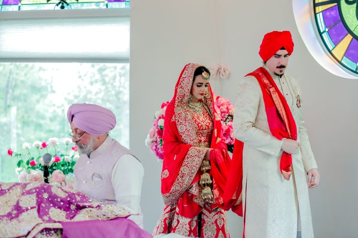 The author and her husband at their Sikh wedding walking around her father and the Guru Granth Sahib. 