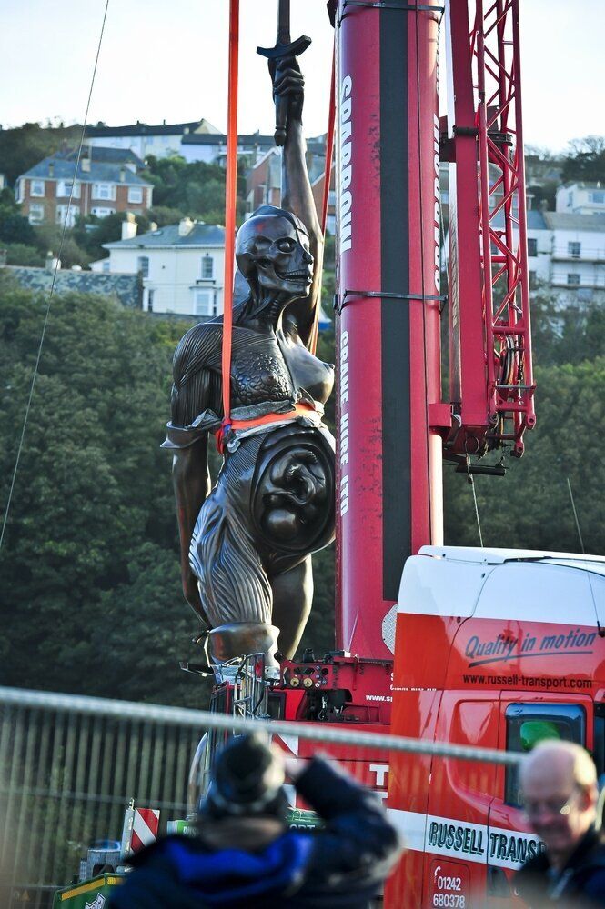 Verity, by Damien Hirst, being erected in Devon