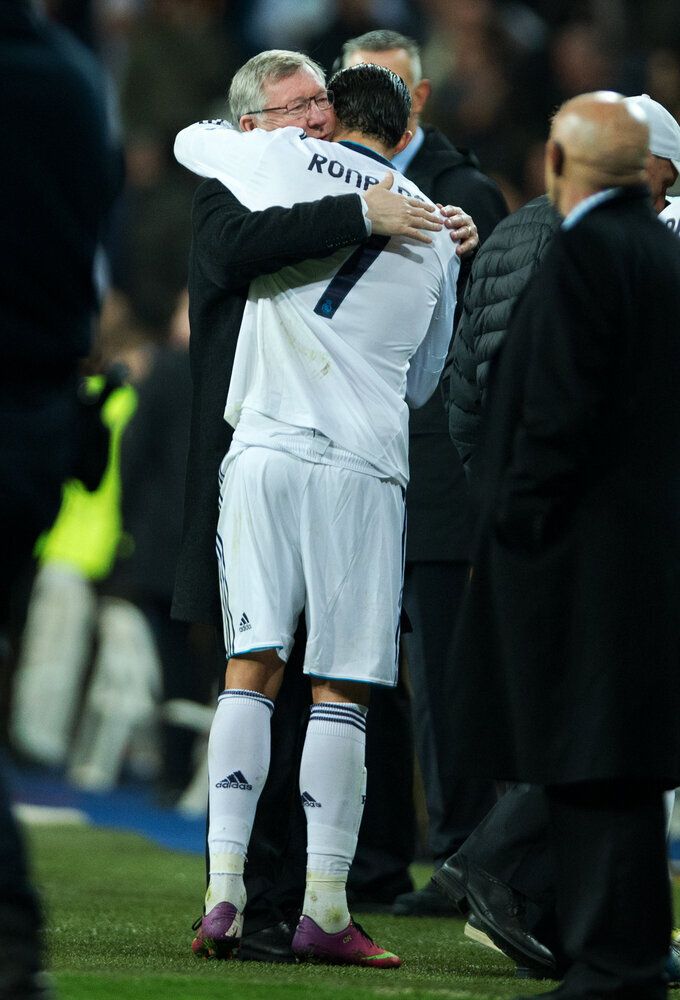 Cristiano Ronaldo (R) of Real Madrid embraces Sir Alex Ferguson