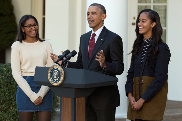 President Barack Obama delivers remarks with his daughters Sasha (left) and Malia (right) during the annual turkey pardoning ceremony in the Rose Garden at the White House in 2015.