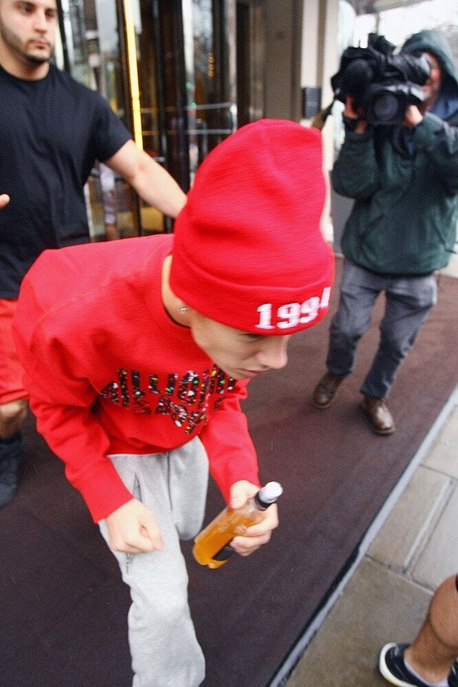 Justin Bieber confronts awaiting photographers outside his hotel this afternoon.