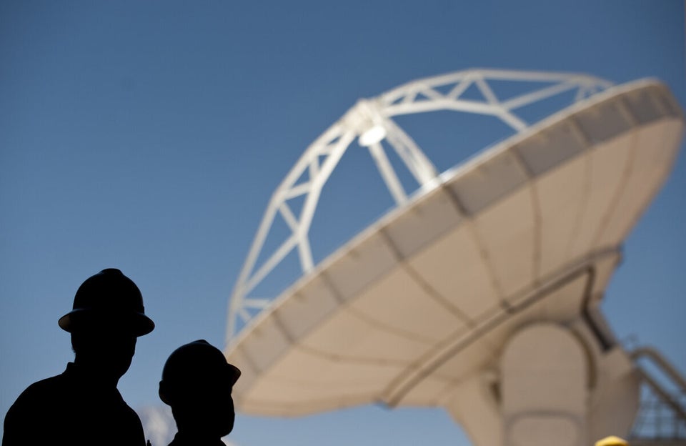 Chilean scientists stand by a radio tele