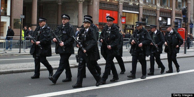 Armed Police walk up the Strand ahead of the funeral of Margaret Thatcher