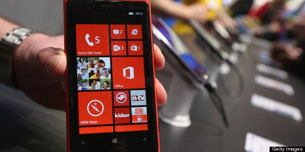 HANOVER, GERMANY - MARCH 05: A stand host holds up a Nokia Lumia 920 Windows enabled smartphone at the Microsoft stand at the 2013 CeBIT technology trade fair on March 5, 2013 in Hanover, Germany. CeBIT will be open March 5-9. (Photo by Sean Gallup/Getty Images)