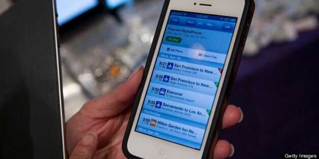 An employee displays the TripIt Inc. mobile app on an Apple Inc. iPhone 5 at Pepcom DigitalFocus in New York, U.S., on Thursday, April 11, 2013. DigitalFocus is Pepcom's annual Spring showcase that previews the tablets, laptops, smartphones, gadgets, videogames, toys, and consumer electronics that will be hot items for the gift-giving season. Photographer: Scott Eells/Bloomberg via Getty Images