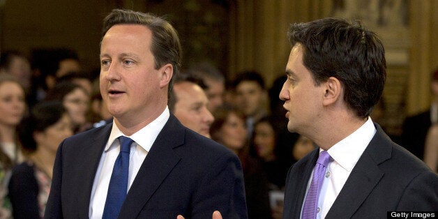 British Prime Minster David Cameron (L) and Ed Miliband, the Leader of the Labour Party, walk through the Members' Lobby to listen to the Queen's Speech at the State Opening of Parliament on May 8, 2013. Heir to the throne Prince Charles and his wife Camilla attended the state opening of Britain's parliament alongside Queen Elizabeth II on Wednesday, in a sign of their increasing role as the 87-year-old monarch scales back some of her duties. AFP PHOTO / ALASTAIR GRANT/POOL (Photo credit should read ALASTAIR GRANT/AFP/Getty Images)