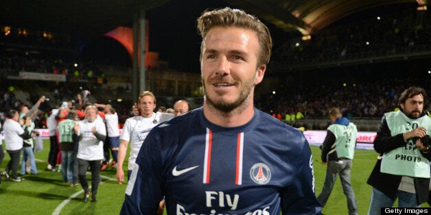 (FILES) Picture taken on May 12, 2013 shows PSG midfielder David Beckham celebrating after Paris Saint-Germain won the French L1 title at the Gerland stadium in Lyon. David Beckham is to retire from professional football at the end of the season, his representative announced on May 16, 2013. AFP PHOTO/PHILIPPE DESMAZES (Photo credit should read PHILIPPE DESMAZES/AFP/Getty Images)